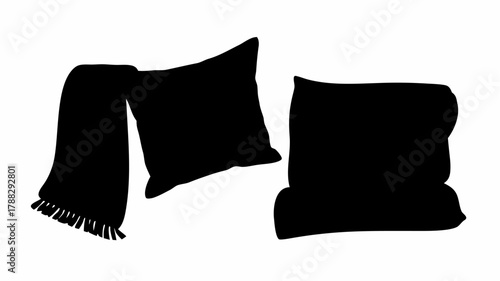 Silhouette of a folded blanket with fringe and two pillows creating a cozy and comfortable scene