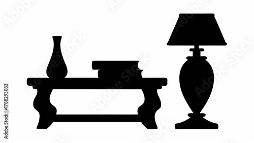 Silhouette of a table with a vase and books next to a floor lamp casting a simple and elegant design