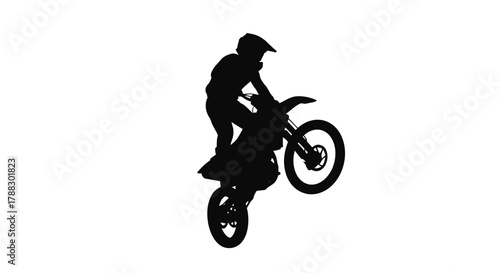 Silhouette of a person riding a dirt bike doing a wheelie against a white backdrop