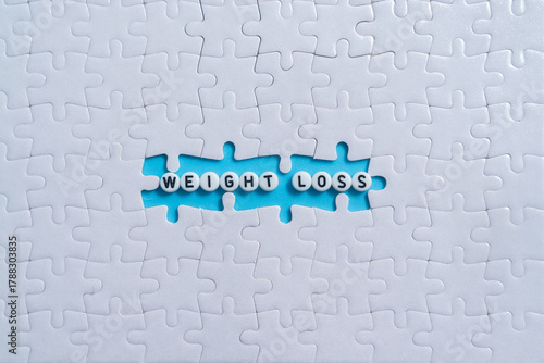 Weight Loss text on light blue background with jigsaw puzzle