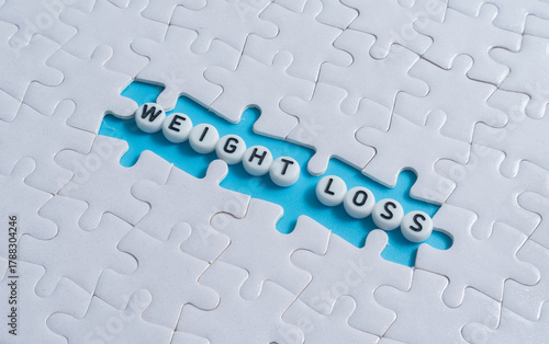Weight Loss text on light blue background with jigsaw puzzle