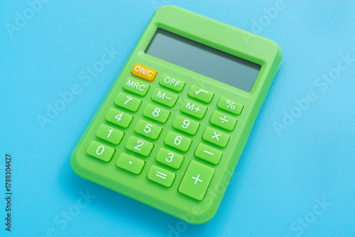 Green color calculator on light blue background