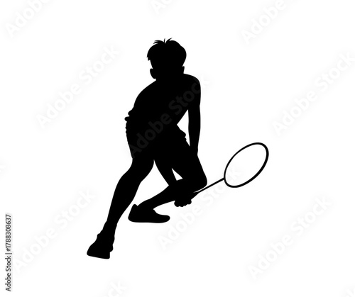 Silhouette of a badminton player in action holding a racquet ready to serve or hit shuttlecock