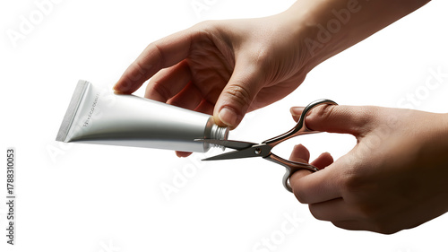 Hands cutting a squeezed tube with scissors isolated on transparent background