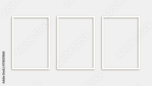 Three blank white photo frames isolated on white background in modern minimalist style for wall decoration and interior design