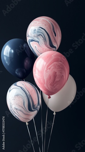 Colorful Marbled Balloons in Pink, Navy, and White Standing Against a Dark Ba...