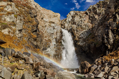 Waterfall Kurkure with rainbow in Altai Mountains territory, West Siberia, Russia.