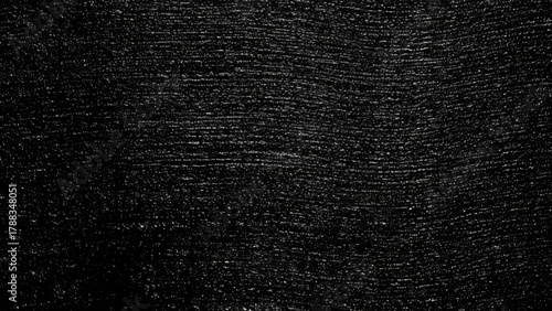 Dark textured surface with subtle linear patterns and granular details, abstract background illustration.