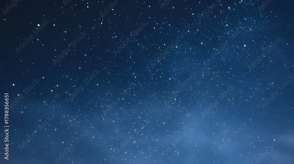 Fototapeta premium An expansive deep blue night sky adorned with thousands of bright twinkling stars creating a serene and magical atmosphere