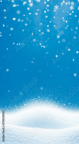 Image of falling snowflake on blue background with snowdrift, representing winter season, holiday spirit, and festive atmosphere, good for holiday concept