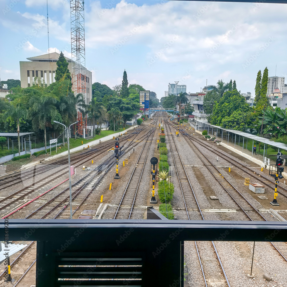 Fototapeta premium Railway Tracks and Signals in Urban Environment Viewed from Elevated Platform at City Station