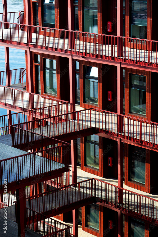 Fototapeta premium Sustainable cabins with natural materials on waterfront in Kvillepiren, Hisingen, sunny day, Gothenburg, Sweden