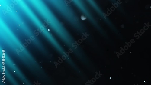 Diagonal beams of blue light shimmer in the darkness and slowly  flying fairy dust. 4K slow motion video at 60 fps.