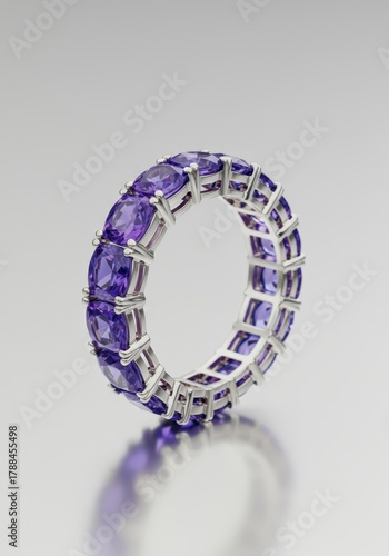 Luxurious eternity band featuring alternating purple amethyst squares and brilliant blue tanzanite ovals set in precious metal ,ring, eternity, jewelry
