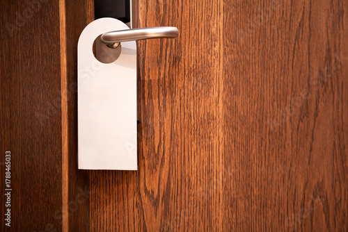 Door knob with blank doorhanger mock up. Empty white flyer mockup hang on door handle. Leaflet design. Dont disturb sign. Hotel room clear hanger. Do not disturbing signal.