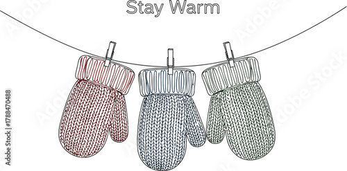 Colorful mittens hanging on a clothesline to dry in a minimalist winter scene