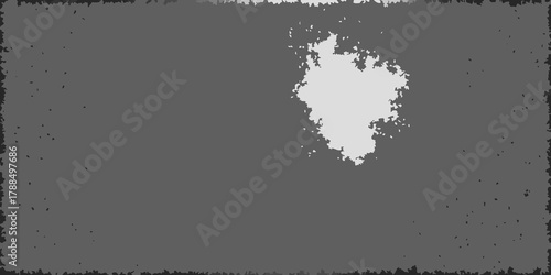 Abstract distressed textured background with a central light grey irregular shape and dark grey rough border