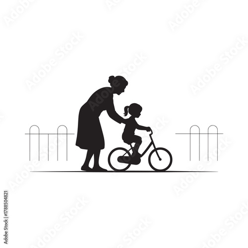 Grandmother teaching child to ride a bicycle silhouette