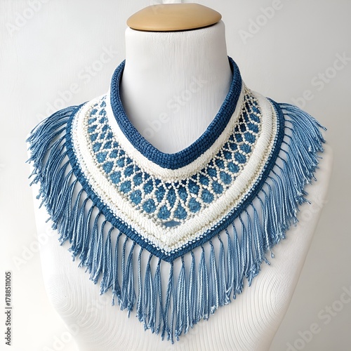 Shirt front with blue fringe and handmade pattern on a white mannequin