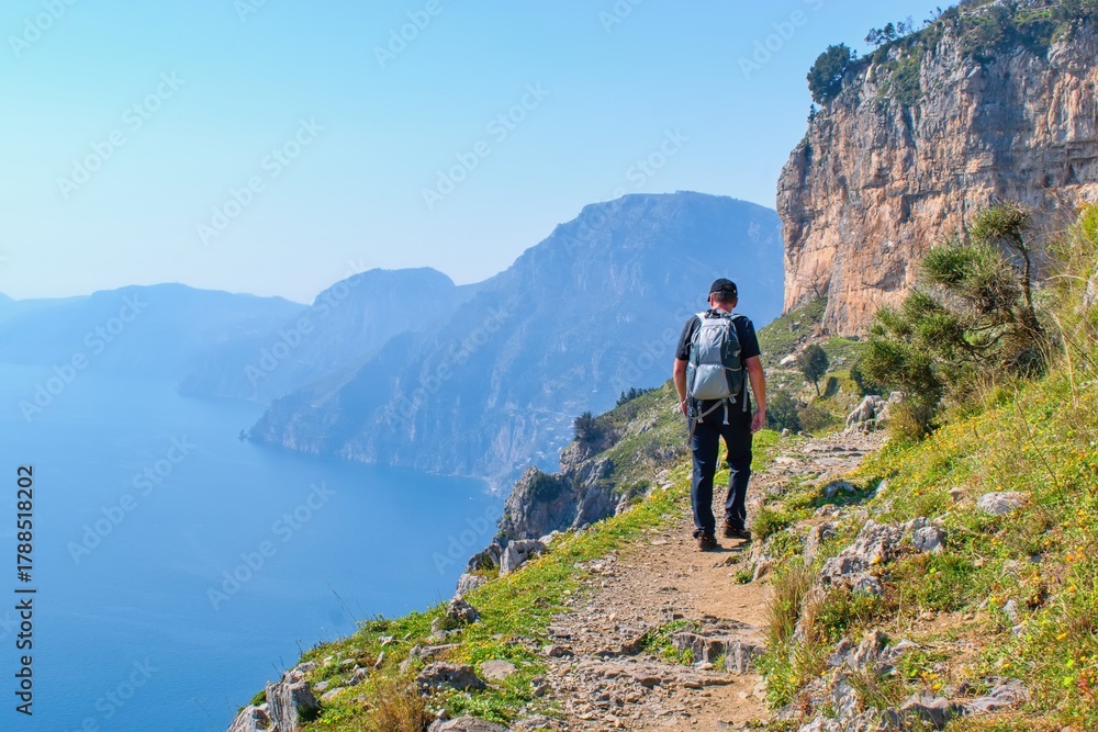 Fototapeta premium Man hiker watching beautiful costal scenery - Path of the Gods