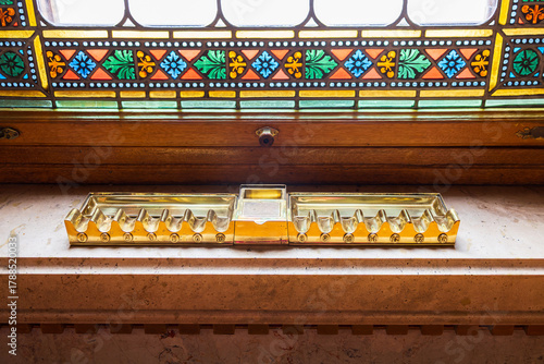 Photography Vintage brass holder for ten cigars set on stained window sill in the 1902 Gothi