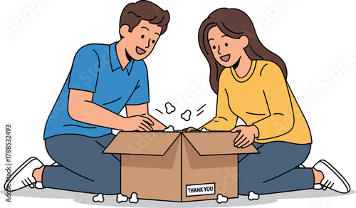 Couple unpacking a cardboard box together
