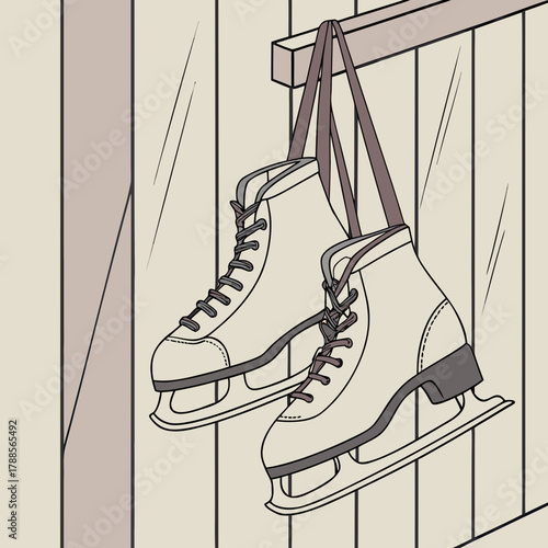 Pair of ice skates hanging by straps on a wooden wall