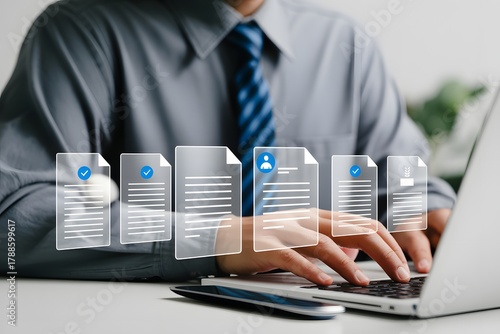 Professional working on laptop with digital document management