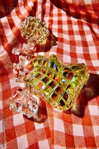 Iridescent Glass Objects on Checkered Red Fabric