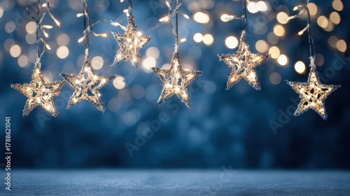 Bright star-shaped garland lights glowing beautifully in cool blue ambiance. Elegant Christmas background representing holiday spirit and joyful decoration