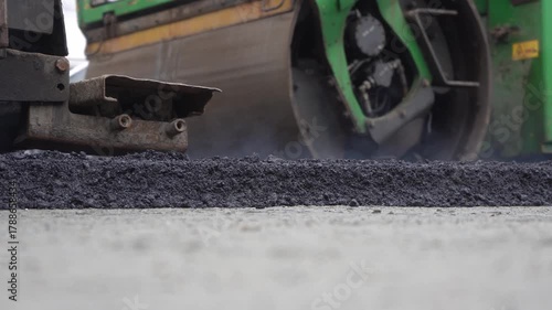 Construction of asphalt roads using an asphalt paver