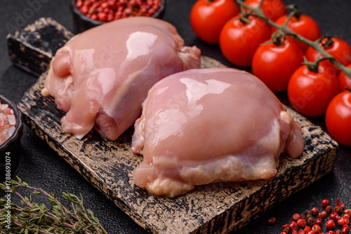 Schilderij op canvas Chicken thigh fillet, skinless and boneless meat for grilling or barbecue