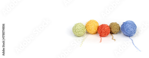 Color yarn on a white background. Cells of woolen yarn for knitting. Balls made of wool of different colors for knitting handmade on a wooden background with a copy space for advertising. Banner.