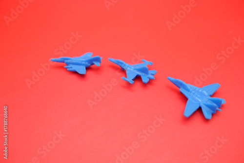 Miniature Jet Fighter Toys Displayed on Red Surface