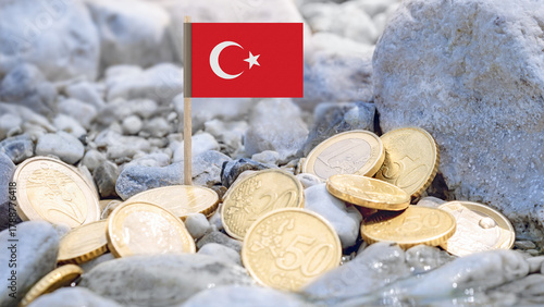 Fototapeta Naklejka Na Ścianę i Meble -  Turkish flag and euro coins on the riverbank,foreign investment,currency exchange,and international finance connected to Turkey and the European economy.