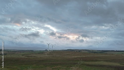 Aerial: A drone footage of a countryside and wind power turbines. West Lothian, Scotland