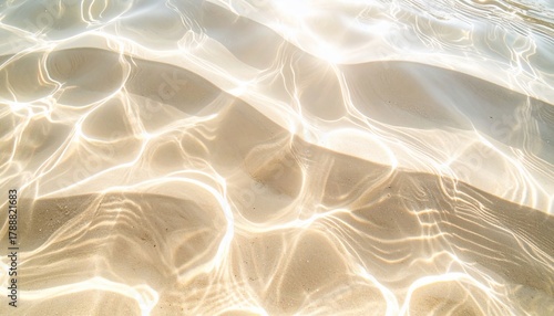 Sunlight reflections dancing on the sandy ocean floor creating an ethereal underwater glow