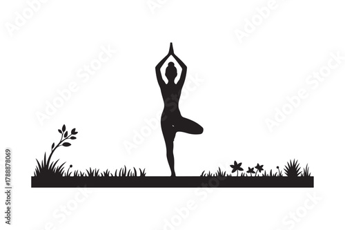 Silhouette of a woman performing tree pose yoga outdoors