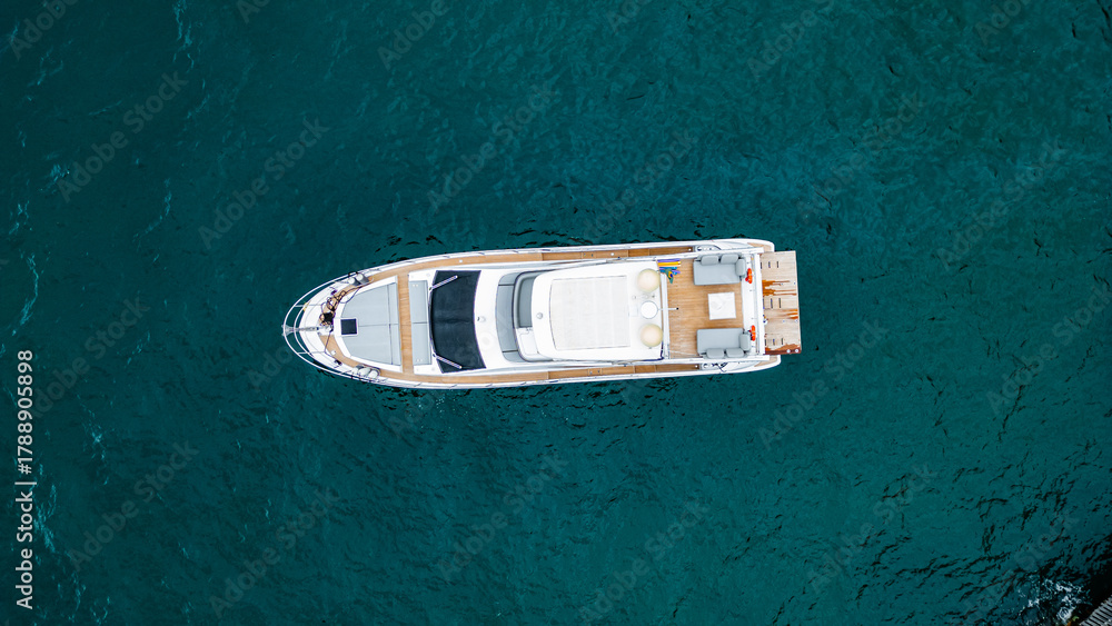 Fototapeta premium Luxury Boat Speedboat Yacht Tropical Paradise Beach Blue Sea Atlantic Ocean Coast Atlantic Forest Angra Dos Reis Rio De Janeiro Brazil South America Idyllic Heavenly Summer Colorful Saturated Green