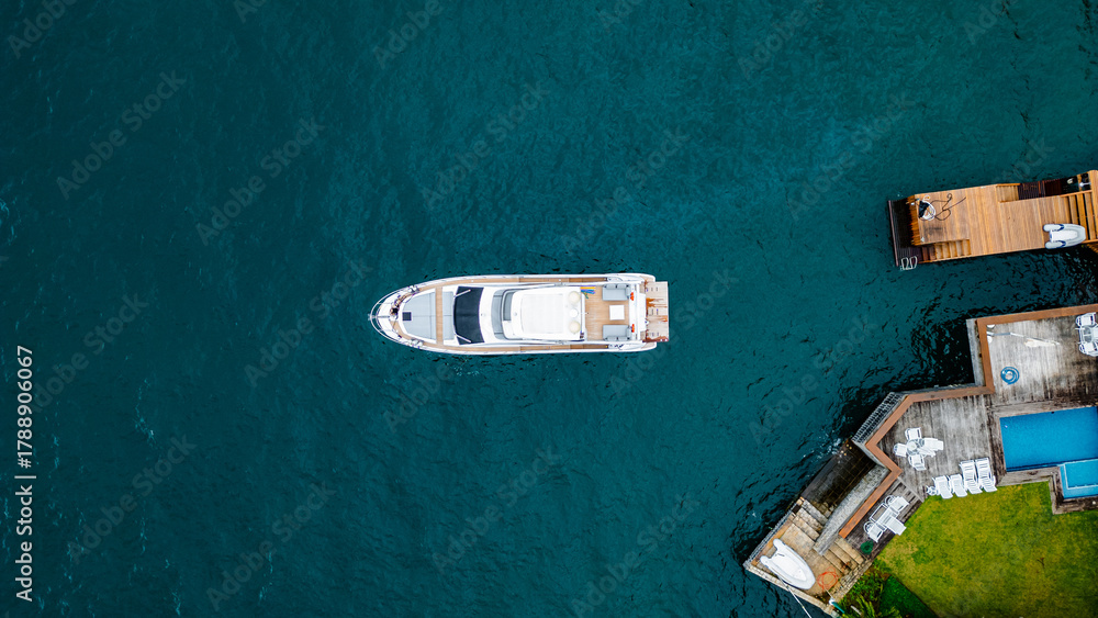 Fototapeta premium Luxury Boat Speedboat Yacht Tropical Paradise Beach Blue Sea Atlantic Ocean Coast Atlantic Forest Angra Dos Reis Rio De Janeiro Brazil South America Idyllic Heavenly Summer Colorful Saturated Green