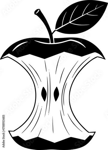 Black apple core with stem and one leaf remains after being partially eaten

