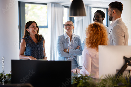 Happy diverse business team enjoying casual office conversation