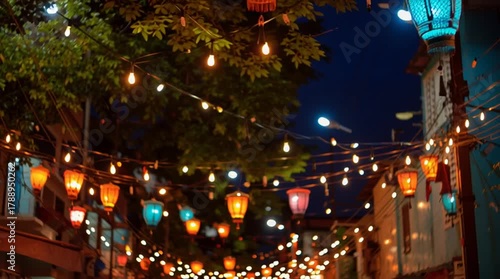 Wallpaper Mural A street decorated with illuminated lanterns and string lights at night creating a festive atmosphere Torontodigital.ca