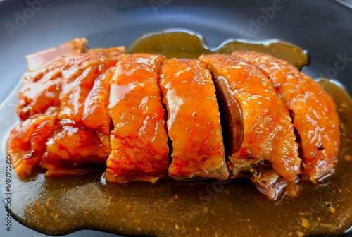 Roasted duck with sauce in plate, indoor Chiangmai Thailand.