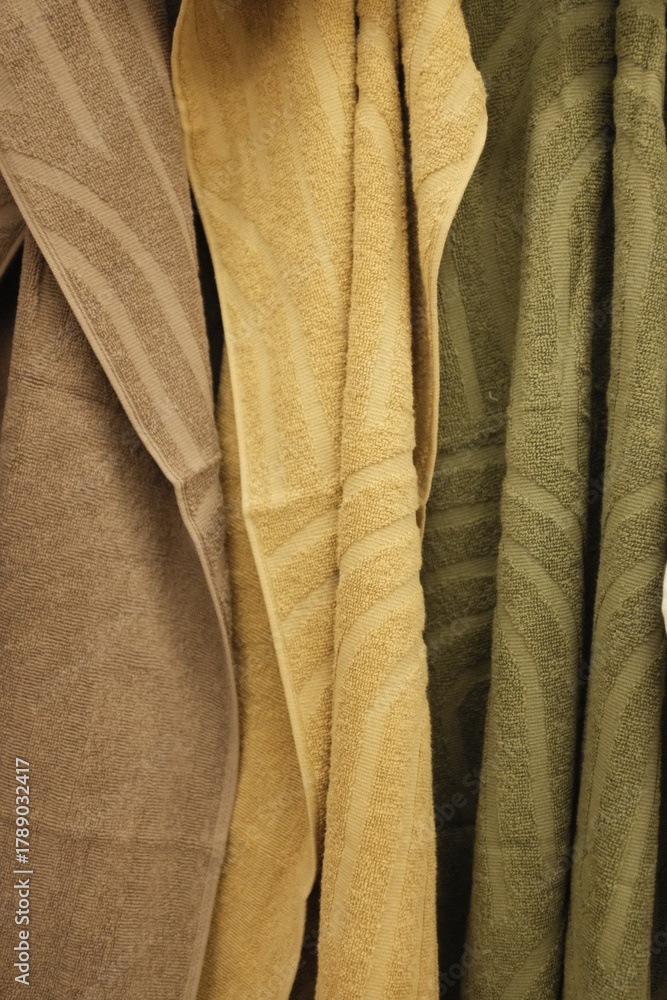 Obraz premium Soft clean towels hanging on a hook. Colorful towels in a laundry room, in bathroom, on a store shelf.