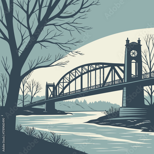 Suspension bridge over a river with clock tower and bare trees water