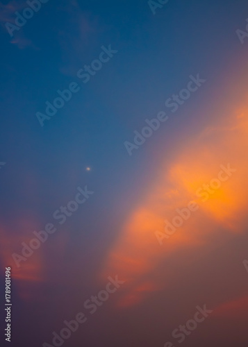 Dawn sky with sunrise rays warming the hazy air