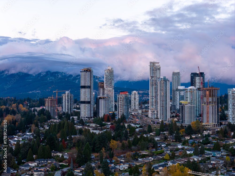 Obraz premium Burnaby City Skyline With Modern Highrise Towers Over Suburban Neighborhoods and Mountains