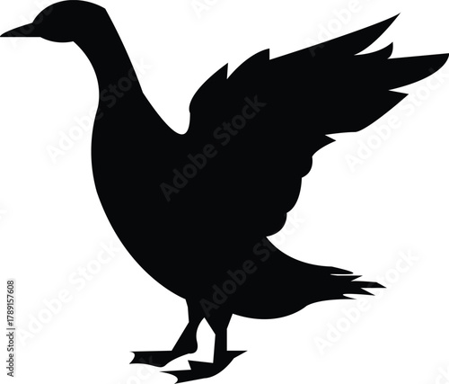 Silhouette of a duck with wings spread, ready to take flight or land