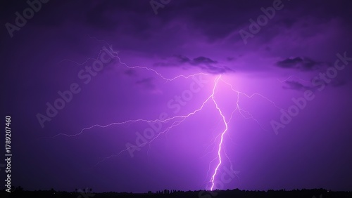 Dramatic purple lightning illuminating a stormy night sky, capturing raw natural energy.